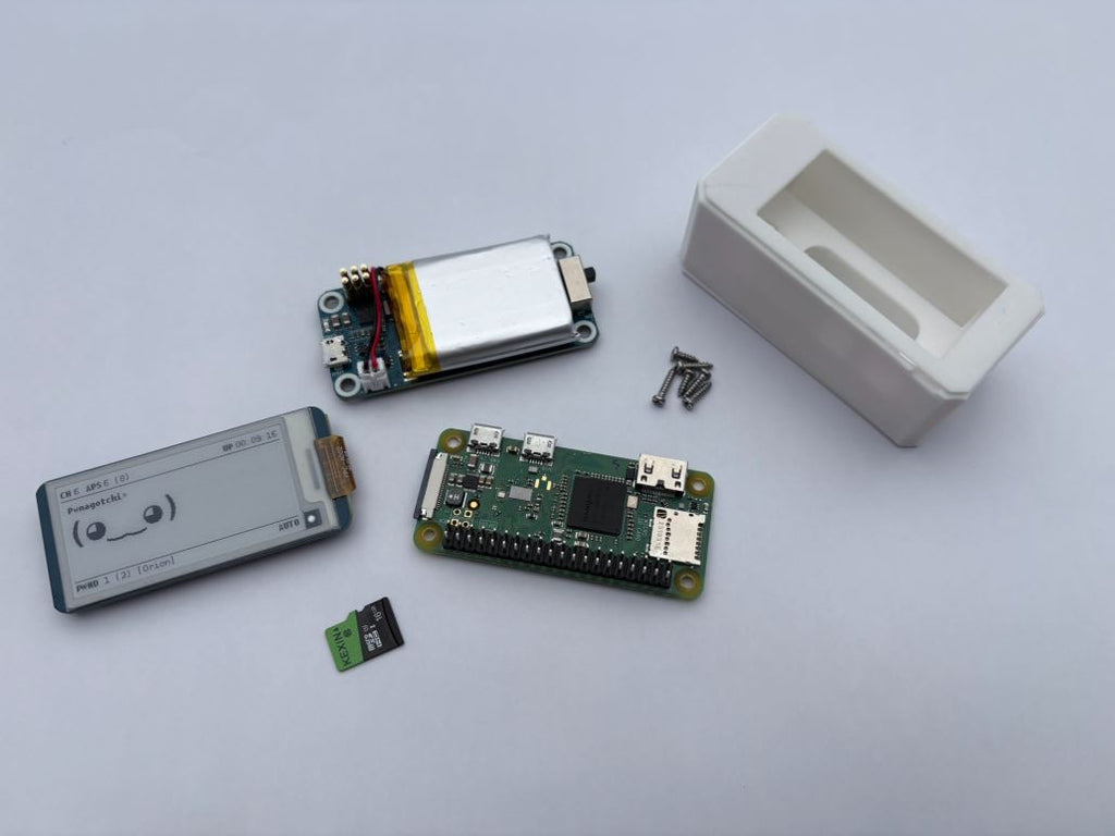 Electronic components including a microcontroller, display module, and small box on a light gray background